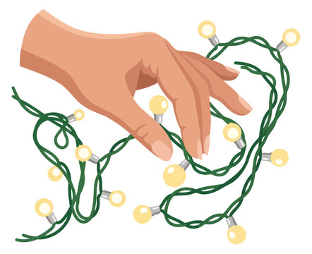Hand untangling a string of yellow christmas lights