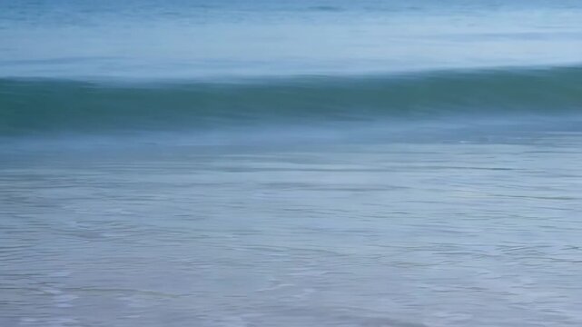 Captures Serene Beach Scene With Main Subject Ocean Gentle Wave Breaking Near Shore Creating Frothy White Foam Contrasts Deep Blue