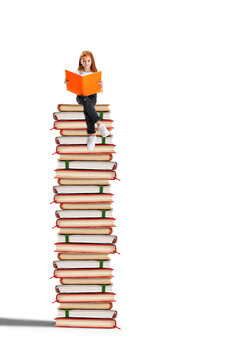 Young reader sits atop towering book stack in white studio with calm confidence. Literacy development, independent study, academic growth concept.