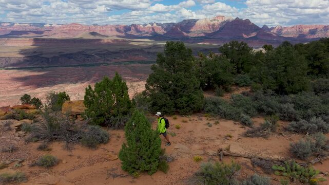 A senior couple explores Gooseberry Mesa in Utah while enjoying views of Zion National Park. They hike through nature and enjoy the sights.