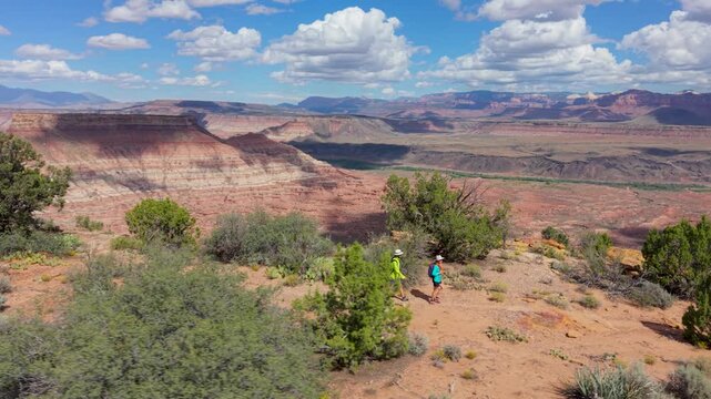 Aerial view of mature couple exploring Gooseberry Mesa while enjoying views of Zion National Park in Utah during their outdoor adventure.