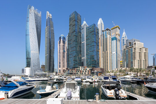 Dubai Marina skyline cityscape with yachts hotel skyscraper buildings living at water in Arabia