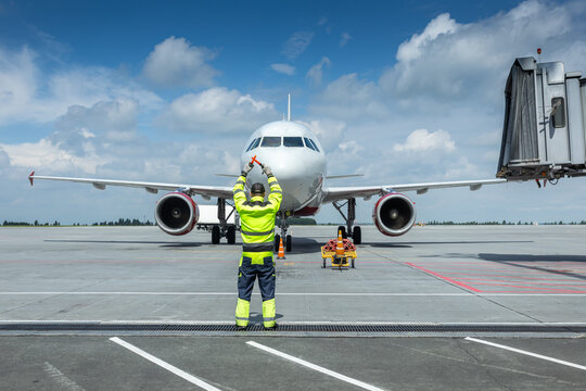 Airplane marshalling at the airport. Passenger aircraft meeting