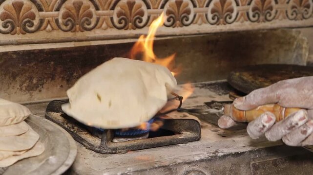Process of Making Traditional Indian Flatbread Roti on Gas Stove Flame.