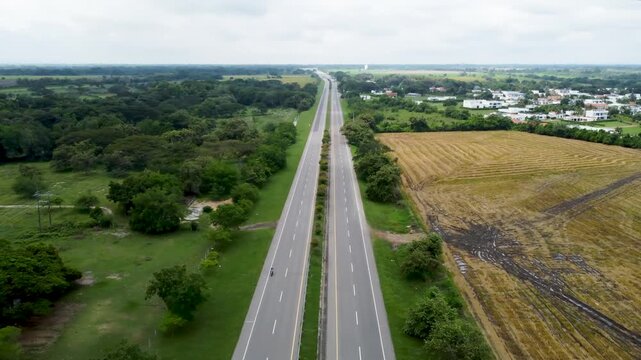 Aerial view drone of empty road clouddy day grass and forest area, Tolima, Colombia 4k