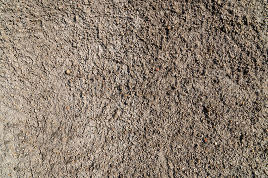 Rough concrete texture with coarse aggregate closeup surface