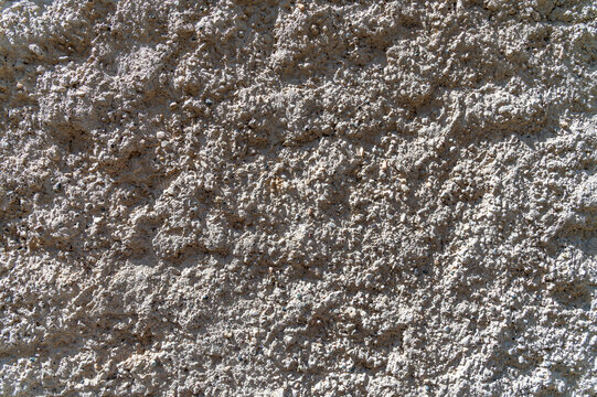 Rough stucco texture covering exterior wall surface