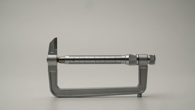 Micrometer secured in a metal c-clamp frame keywords: micrometer, c-clamp, frame, measurement