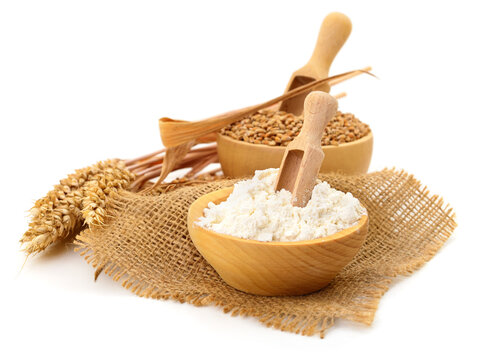 wheat flour and grain in wooden bowls with scoop isolated on white background