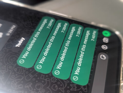 Smartphone screen showing deleted message notifications on chat app close up stock photo