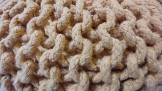 Macro close up texture of beige knitted cotton rope furniture pattern