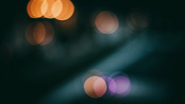 Abstract blurred bokeh lights with colorful circles and soft glow in dark environment