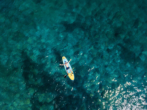 Man Sunbathing on a SUP Board