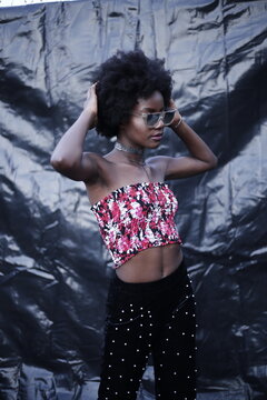A Model posing in stylish & fashion way on dark texture background
