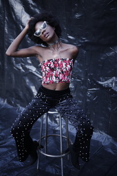 A Model posing in stylish & fashion way on dark texture background