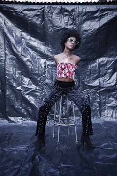 A Model posing in stylish & fashion way on dark texture background