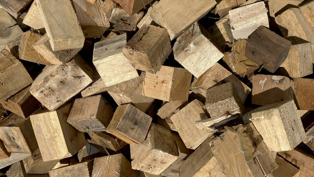 Large pile of rough cut square wooden blocks background