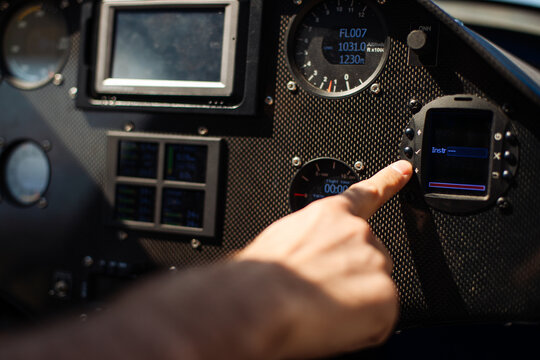 Pilot Pointing At Aircraft Cockpit Instruments During Preflight