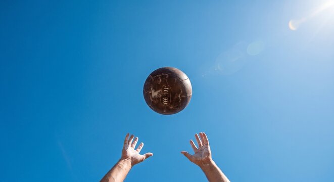 Medicine Ball Thrown in Air Against Blue Sky Copy Space