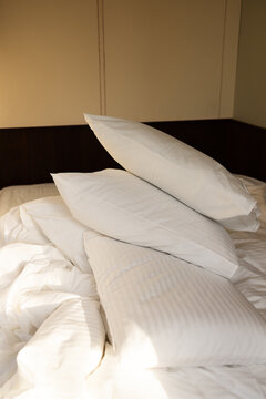 Stack of Fluffy White Pillows with Soft Morning Sunlight