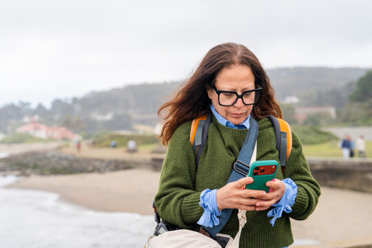 casual woman using cellphone outside
