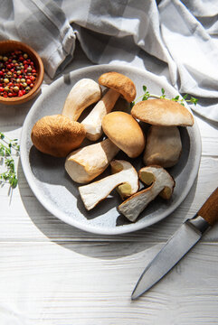 Fresh porcini mushrooms preparing for cooking with herbs