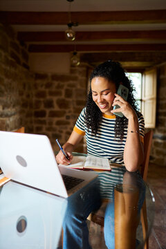 Woman multitasking working remotely from home office