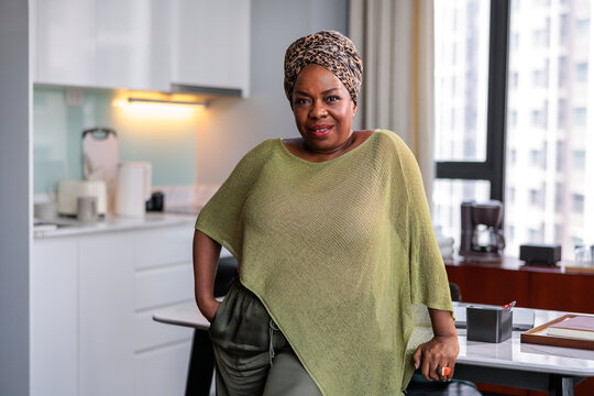 A stylish, confident woman standing in her modern kitchen