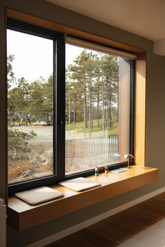 Minimalist window bench overlooking a forest view