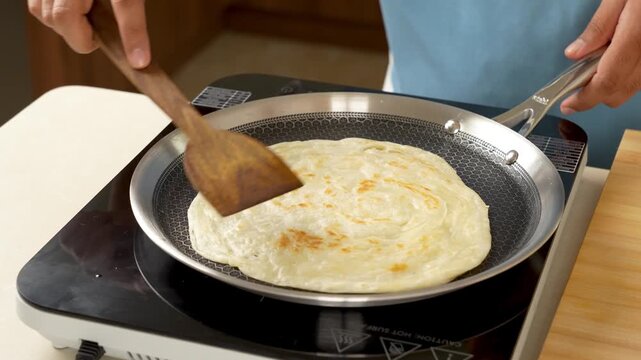 Golden Brown Paratha Cooking on Pan