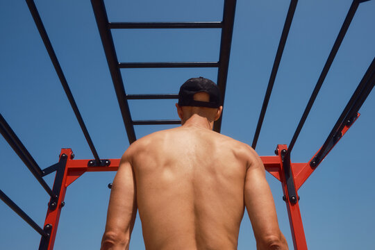 Outdoor calisthenics training under a blue sky