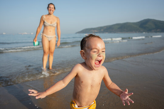 toddler playing on beach