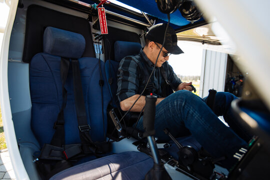 Pilot Performing Preflight Check in Cockpit