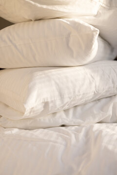 Stack of Fluffy White Pillows with Soft Morning Sunlight
