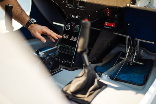 Pilot Adjusting Controls in Small Airplane Cockpit
