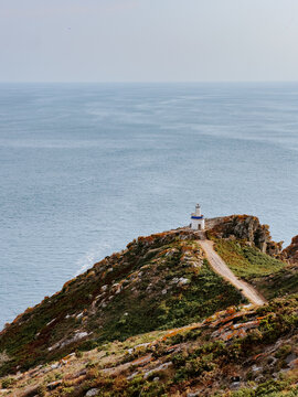 Faro da Porta lighthouse on cliff above Atlantic sea in Galicia