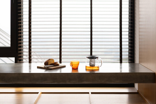 Freshly Brewed Tea in Glass Mug with Sliced Cake on Kitchen Counter