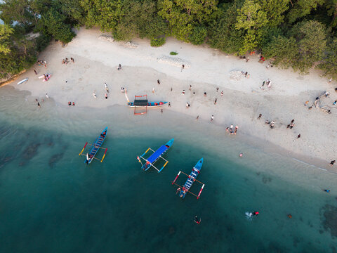 Beach Visitors and Outrigger Boats Seen from Above