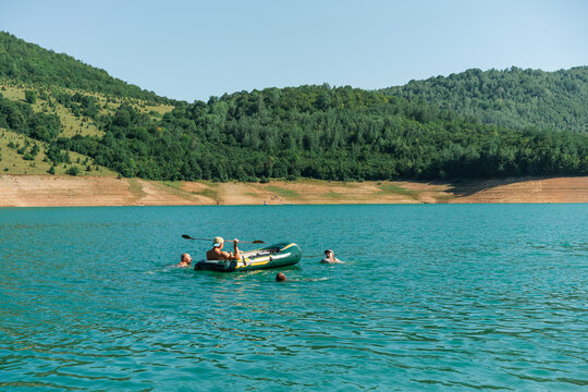 Summer Lake Fun With Inflatable Boat and Swimmers