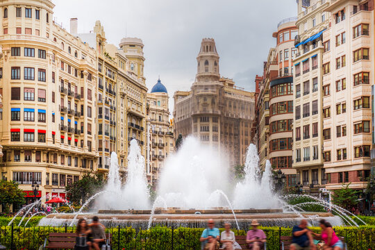 City square historic buildings fountain people benches street