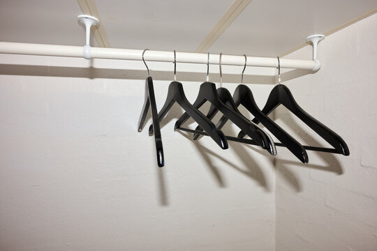 Close-up of hangers in a budget hotel wardrobe.