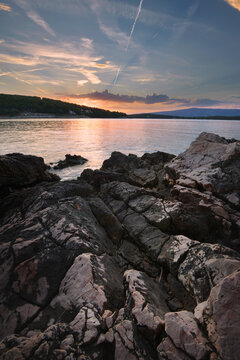 Sunset over rocky sea coast in Croatia with dramatic sky