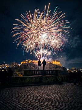 Couple watching fireworks during New Year's celebration in Edinburgh  