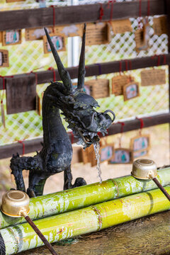 Water flows from a chozuya trough with ladles for water ablution use in a ceremonial purification rite known as temizu. Chozuyas are located at every entrance to shrines and temples in Japan.