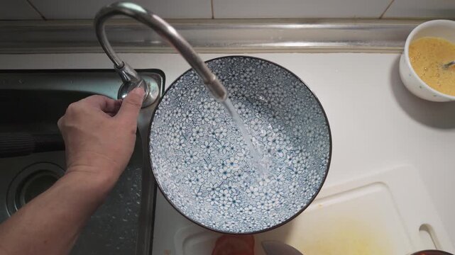 Filling Traditional Blue Patterned Bowls with Filtered Water