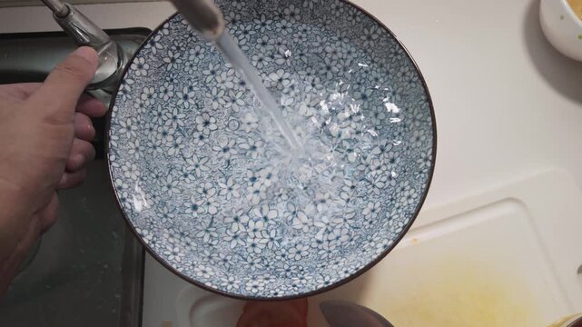Filling Traditional Blue Patterned Bowls with Filtered Water