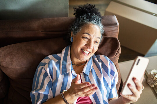 Smiling senior woman on a video call at home