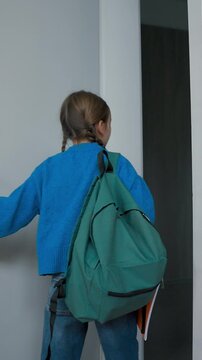 Back view Caucasian child girl kid schoolgirl going walking in school corridor come in classroom. Little pupil go walk in hallway rushing to class lesson exams elementary education learning studying