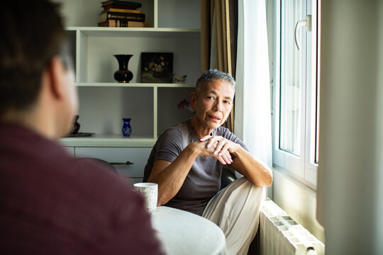 Older woman listening during a serious talk at home