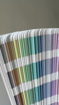 Hand Fanning Open a Printed Colour Swatch Guide Vertical
